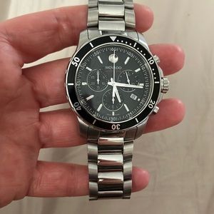 Silver with black face 42” men’s movado. Series 800